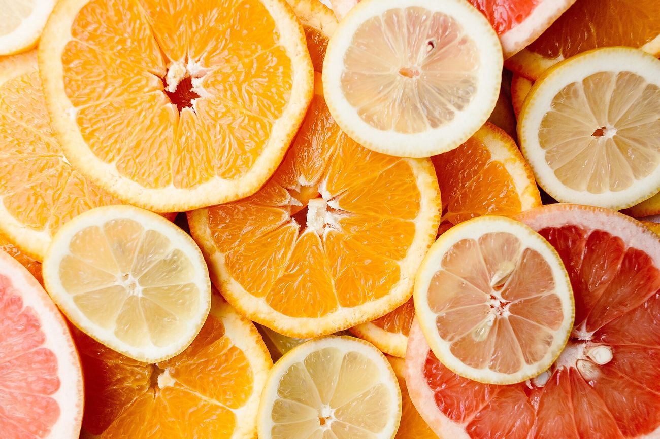 Sliced citrus fruit including orange, lemon, and grapefruit